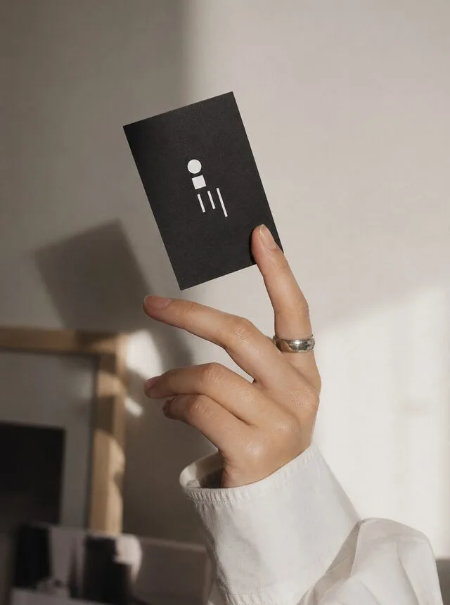 Hand holding a Simply Works Marketing business card